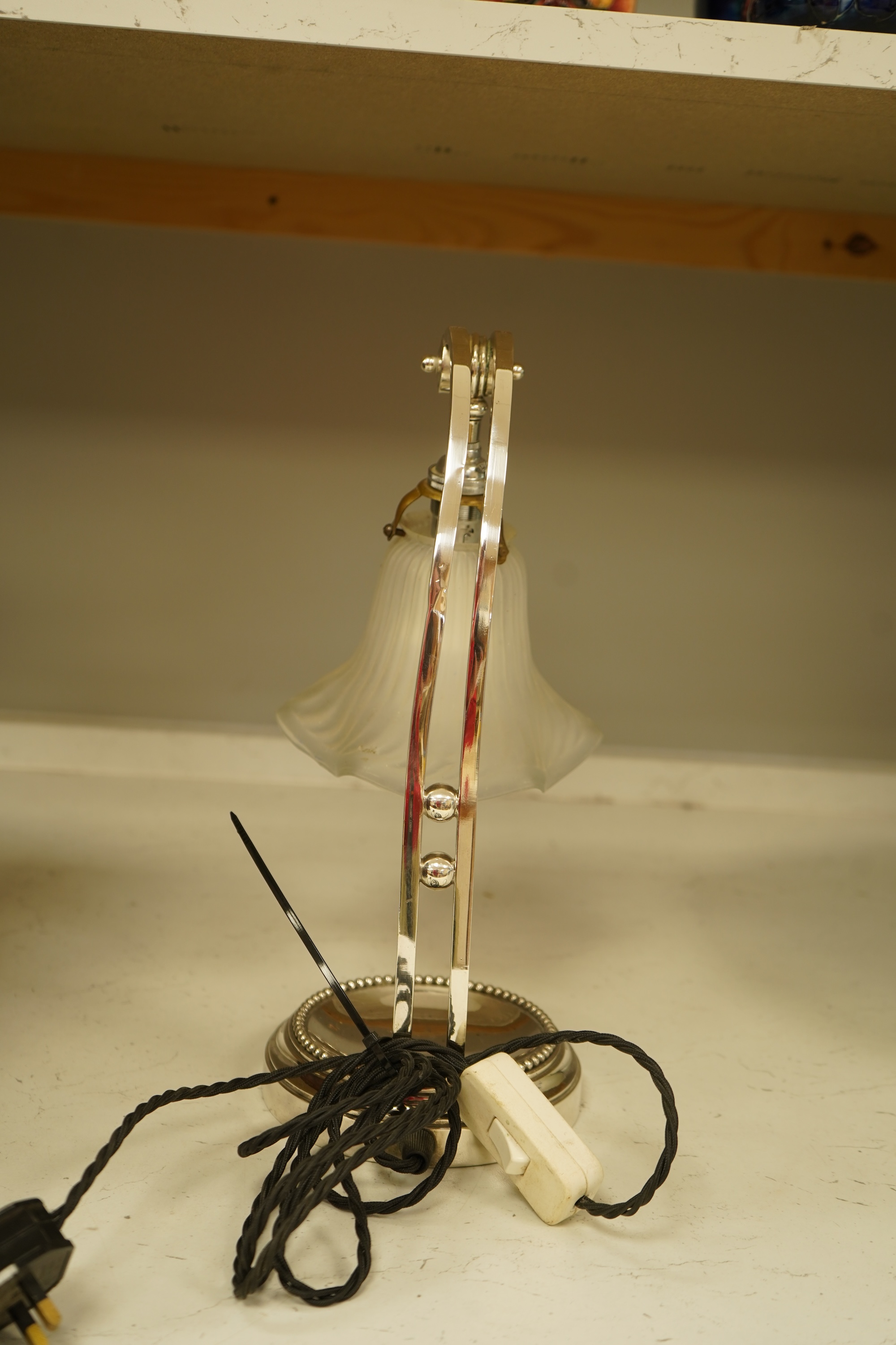 A plated adjustable desk light with opaque glass fluted shade, 35cm high